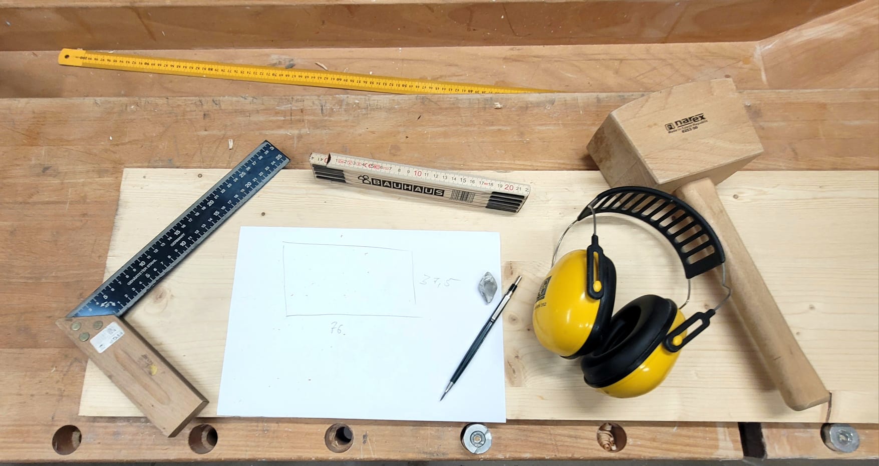 Person working with woodworking tools on a piece of wood